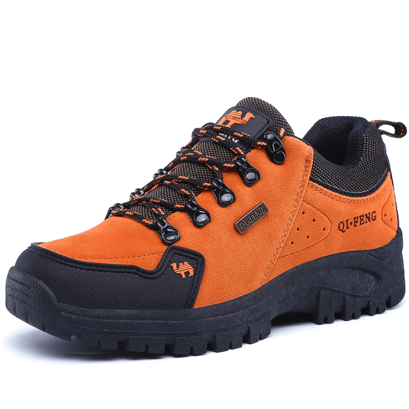 Orange non-slip waterproof hiking shoe with black accents and rugged rubber sole, ideal for outdoor trekking and maximum performance.