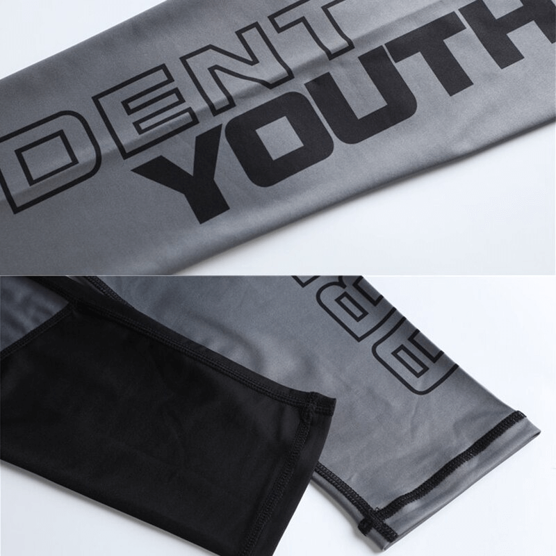 Gray and black athletic compression male tights with stylish text design.