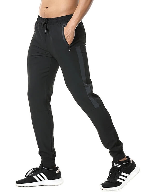 Men's athletic soccer running trousers with zip pockets, showcasing flexible fit and elastic waistband, ideal for active sports.