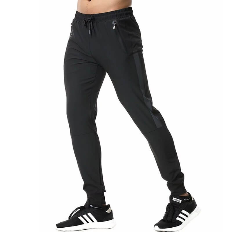 Men's athletic soccer running trousers with zip pockets, black, elastic waistband, designed for comfort and flexibility in sports.
