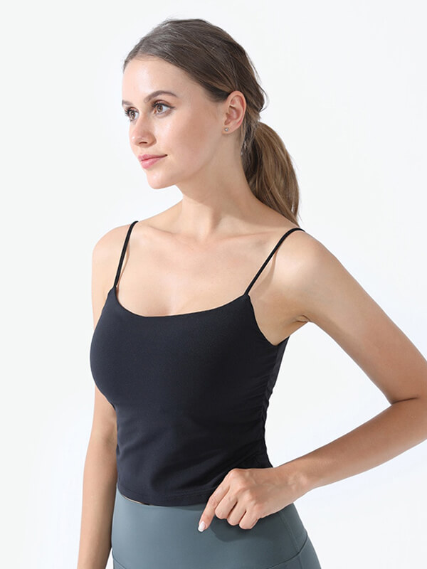 Woman wearing black athletic women's strap thin camis, ideal for yoga, showing an anti-friction nylon fabric with a flattering fit.