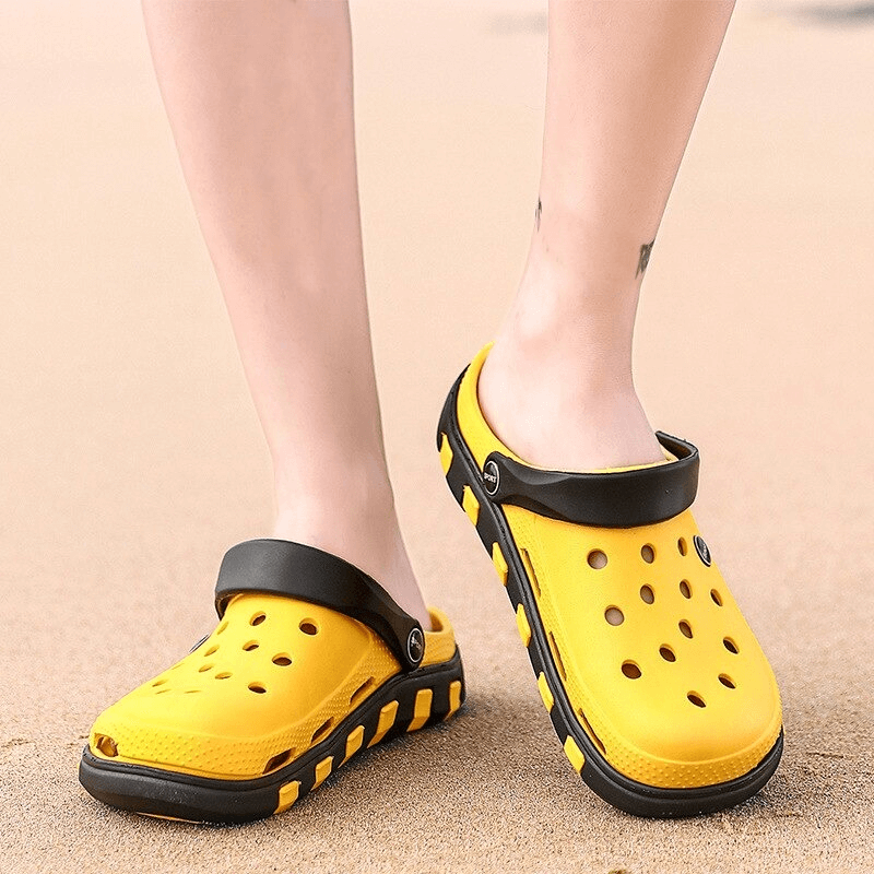 Yellow lightweight quick-drying sandals with anti-slip soles on sand, perfect for beach and outdoor activities, showcasing flexible rubber design.