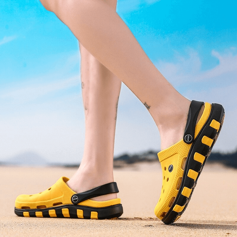 Yellow quick-drying beach sandals with flexible rubber sole, perfect for outdoor adventures. Comfortable and stylish footwear on sandy beach.