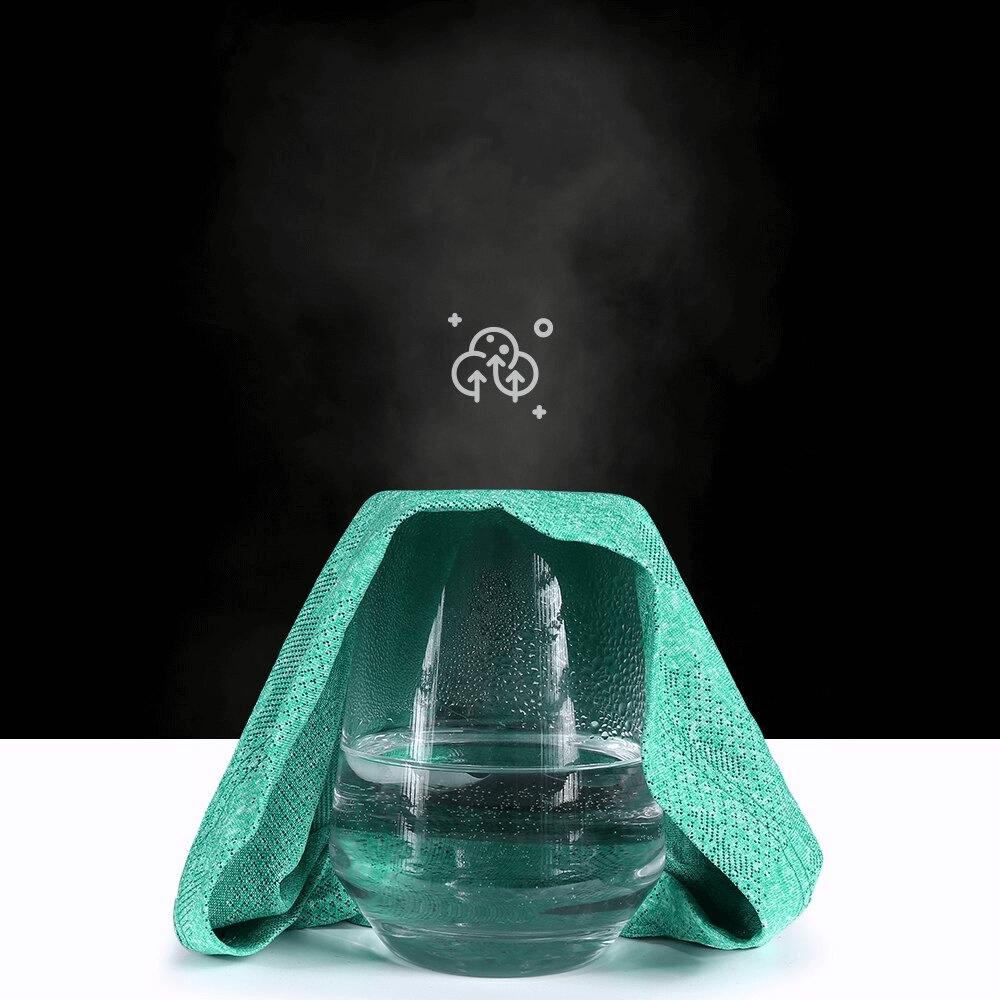 Green quick-dry running hat demonstrating breathability over a steaming glass bowl, set against a black background.