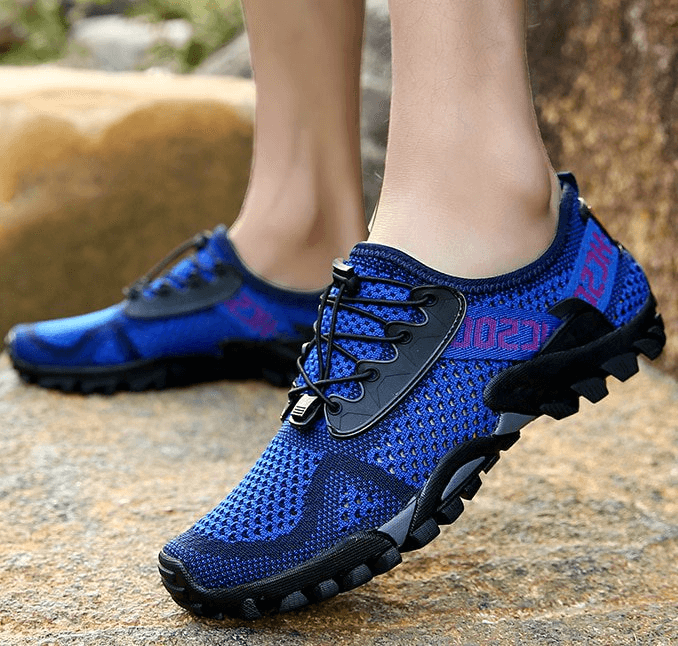 Men's breathable elastic camping shoes with blue mesh upper, black rubber sole, and lace-up closure, perfect for outdoor activities.