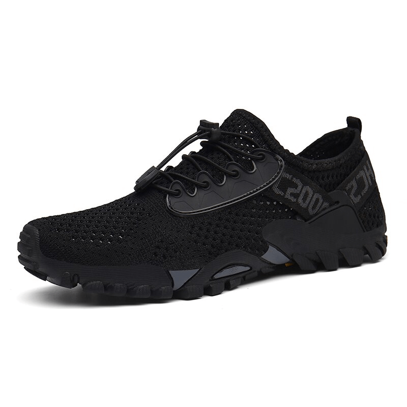 Black breathable elastic camping shoes with a mesh upper, durable rubber outsole, and lace-up closure for outdoor adventures.