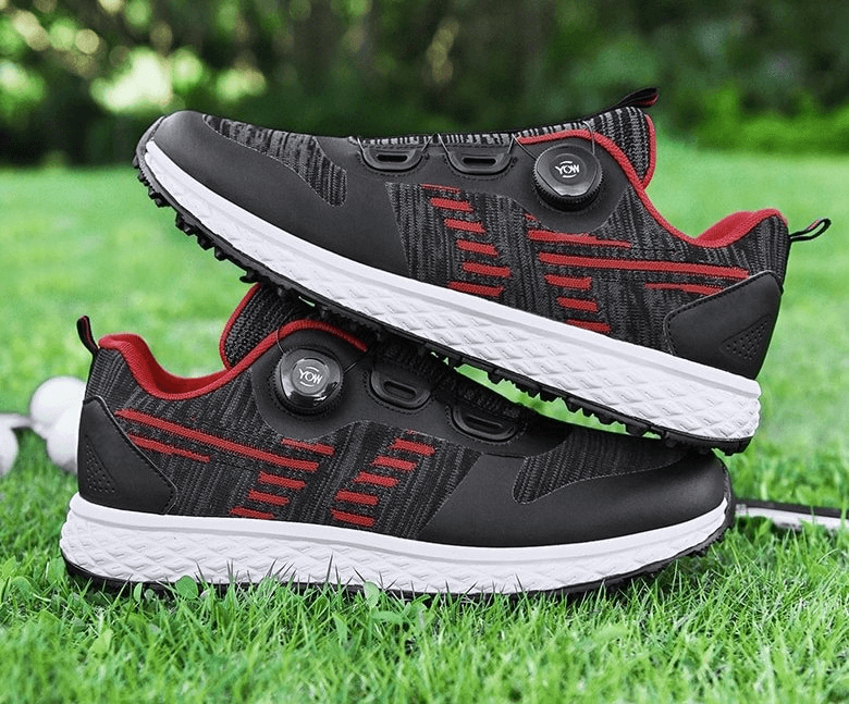 Red and black breathable flexible casual lace-up sneakers on grass, featuring air mesh upper and rubber sole for comfort and durability