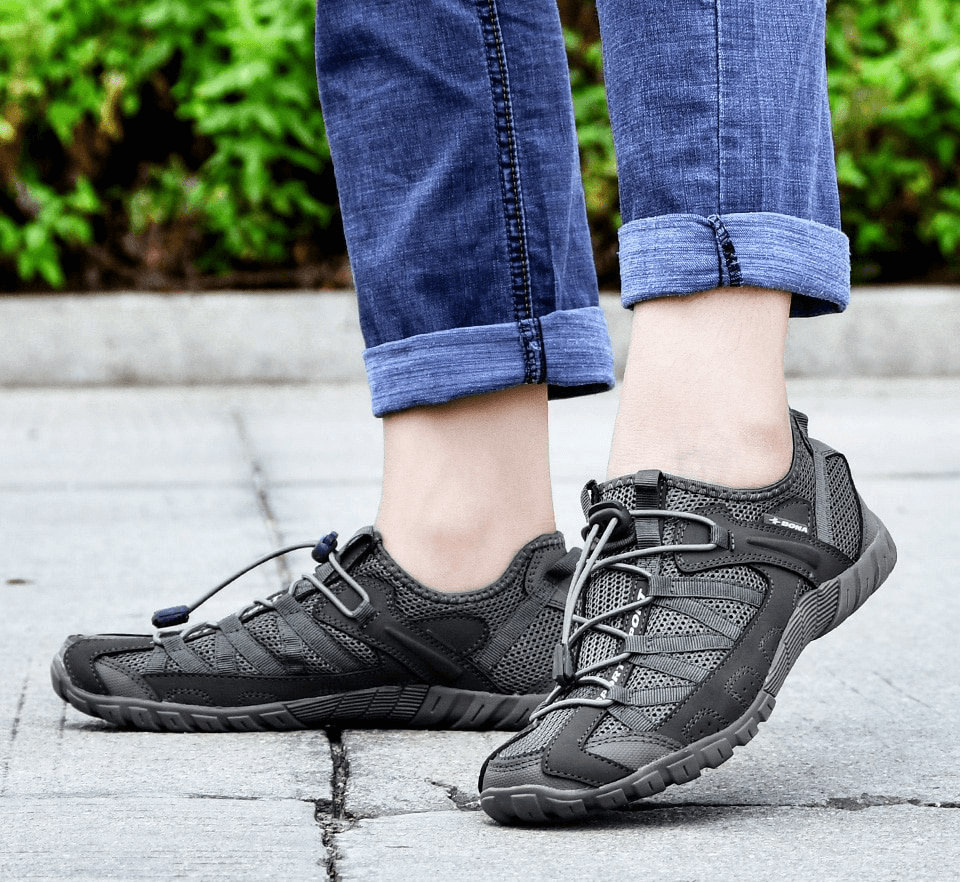 Person wearing breathable mesh flexible sneakers for men, SF0758, showcasing lightweight sports footwear with elastic band closure.
