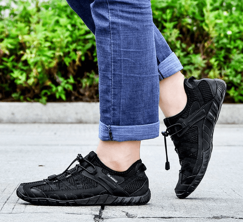 Breathable mesh flexible sneakers for men in black with blue jeans, highlighting lightweight comfort and sporty style SF0758.