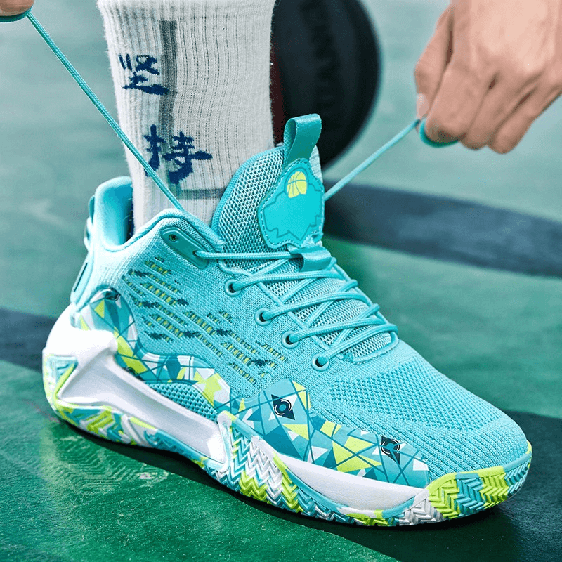 Vibrant turquoise breathable mesh sports shoes with cushioning and geometric design on a green court, perfect for active performance.
