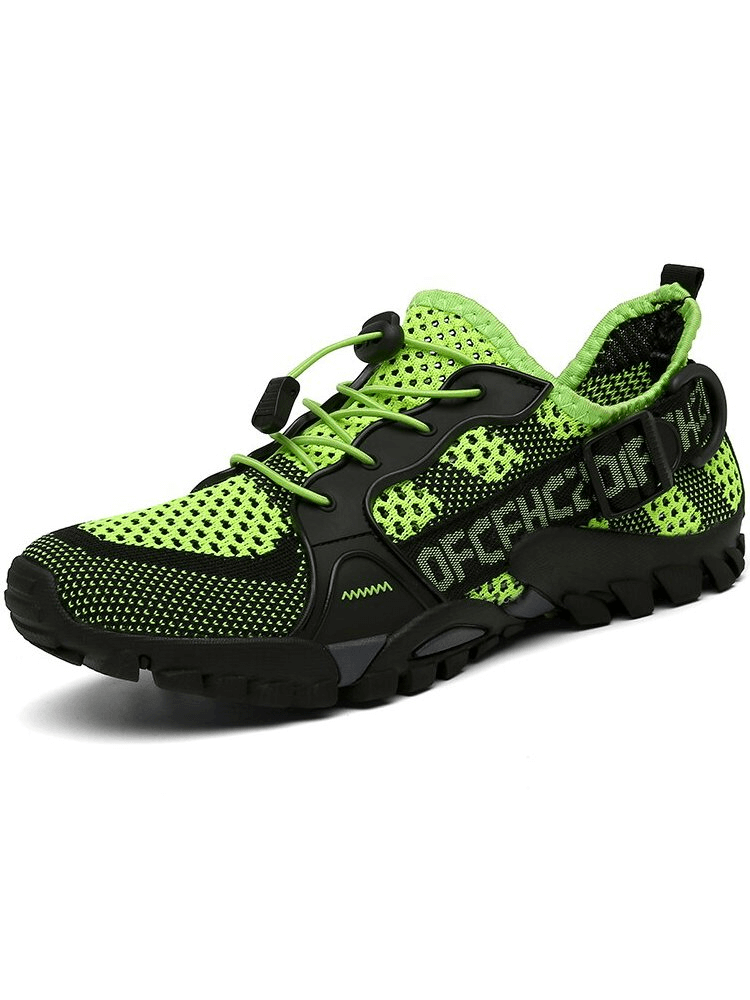 Green breathable mesh trekking shoe with elastic band closure and durable rubber outsole for outdoor adventures.
