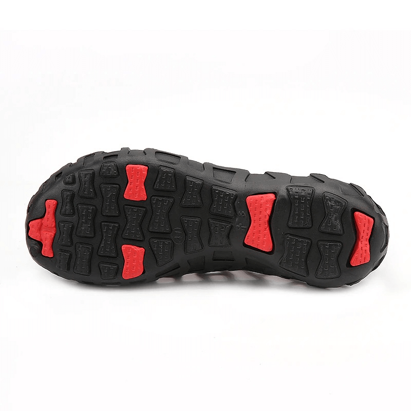 Close-up view of the durable rubber outsole for breathable beach slippers SF0259, highlighting the red and black tread design.