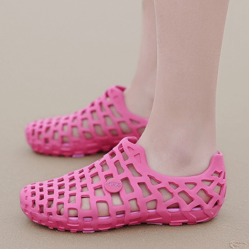 Pink breathable rubber beach slippers for unisex use, perfect for water activities and leisure, featuring durable synthetic material.