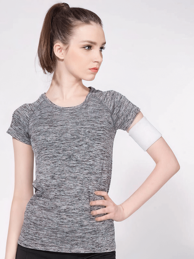 Woman in breathable short sleeves t-shirt for sports, showcasing quick-dry fabric, perfect for yoga and jogging. Stylish and functional activewear.