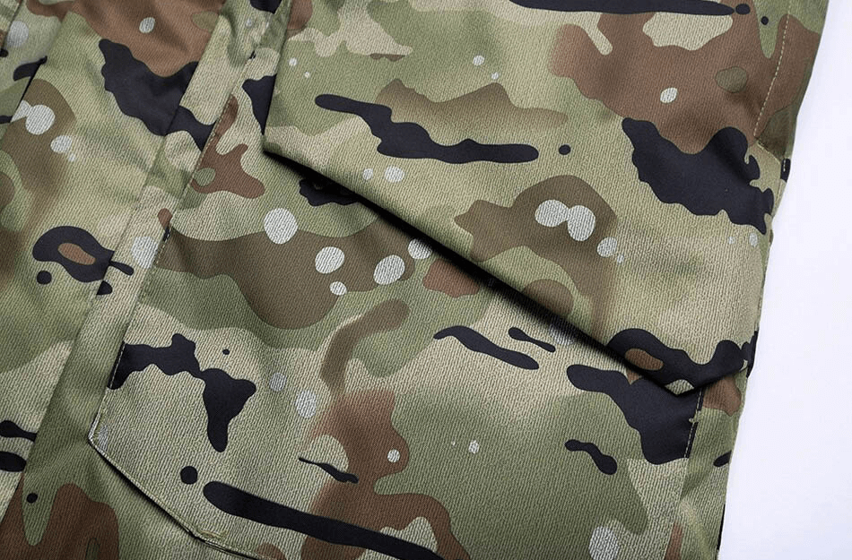 Close-up of camouflage pattern on waterproof men's snowboard jacket, perfect for staying dry and warm on the slopes.