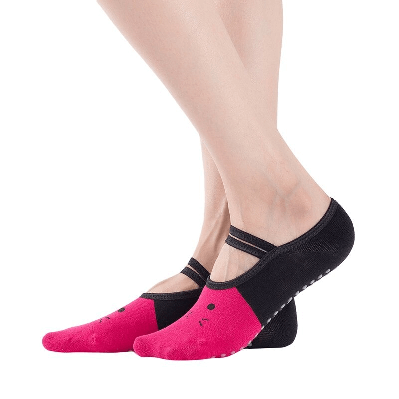 Woman wearing cartoon cat print anti-slip yoga pilates socks with pink and black design, showcasing comfortable fit and grip.