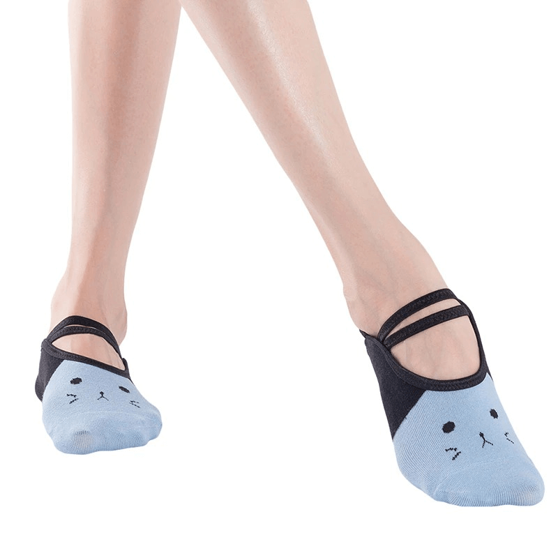 Woman wearing cartoon cat print anti-slip yoga socks for superior grip and comfort during exercise.