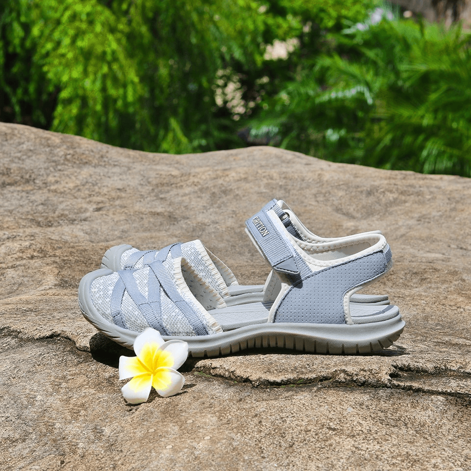 Grey casual closed toe flat heels women's sandals with hook & loop closure, perfect for trekking and travel, displayed on a rock.