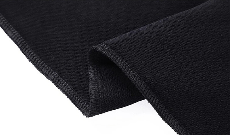 Close-up of black cotton fabric detail from men's elastic waist sweatpants with fleece material, showcasing durability and comfort.
