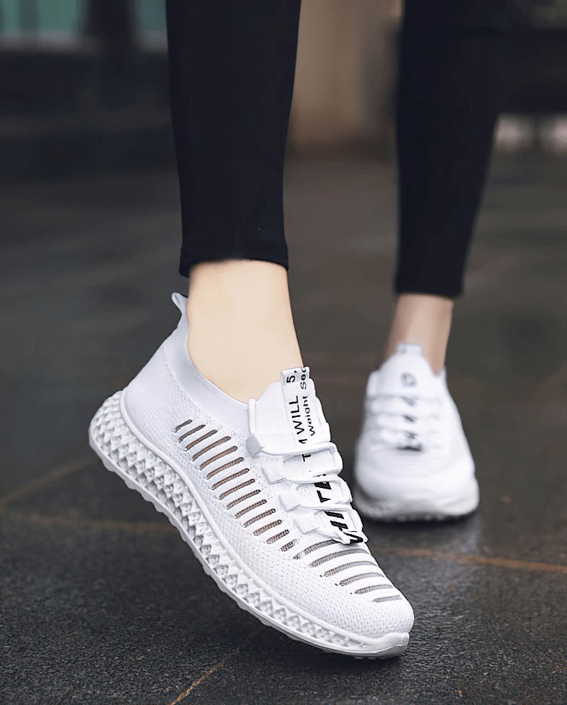 White mesh lace-up sneakers for women with flat bottoms, perfect for walking.