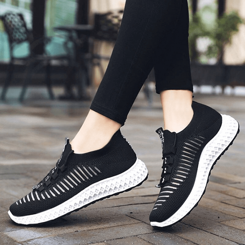 Casual lace-up flat bottom black sneakers for women, breathable mesh design, perfect for walking.