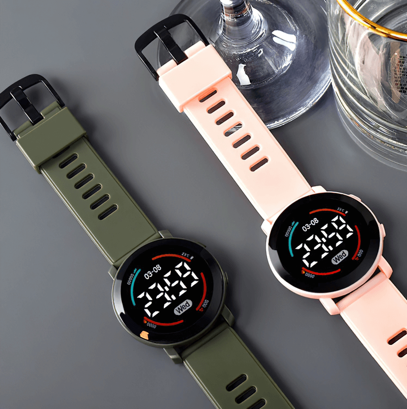 Casual LED digital wristwatch SF0438 with sleek design, silicone band, waterproof, unisex; displays time and date. Available in green and pink.