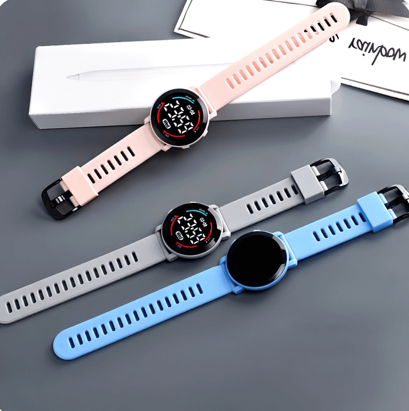 Three casual LED digital wristwatches in pink, gray, and blue with silicone bands and sleek design, perfect for daily wear and trendsetters.