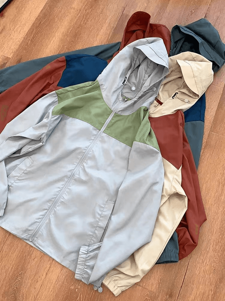 Casual light thin breathable hooded patchwork jackets in gray, khaki, and coffee laid on wooden floor. SF0909 summer style.