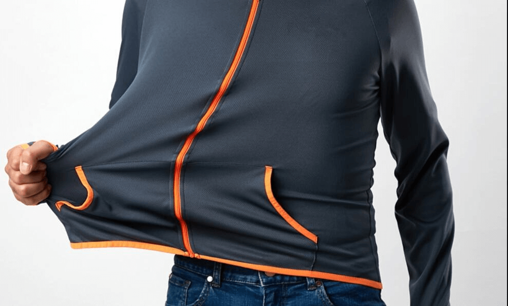 Man wearing a casual lightweight thin sunscreen jacket in dark color with orange accents, showcasing the stretchable, breathable fabric.