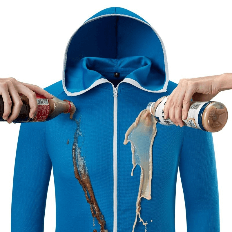 Waterproof blue sunscreen jacket with liquids pouring onto it, showcasing its stain-resistant properties.