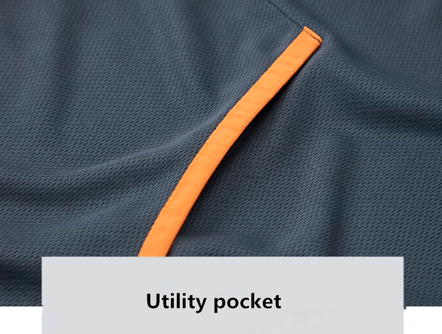 Close-up of utility pocket with orange trim on a lightweight casual men's jacket.