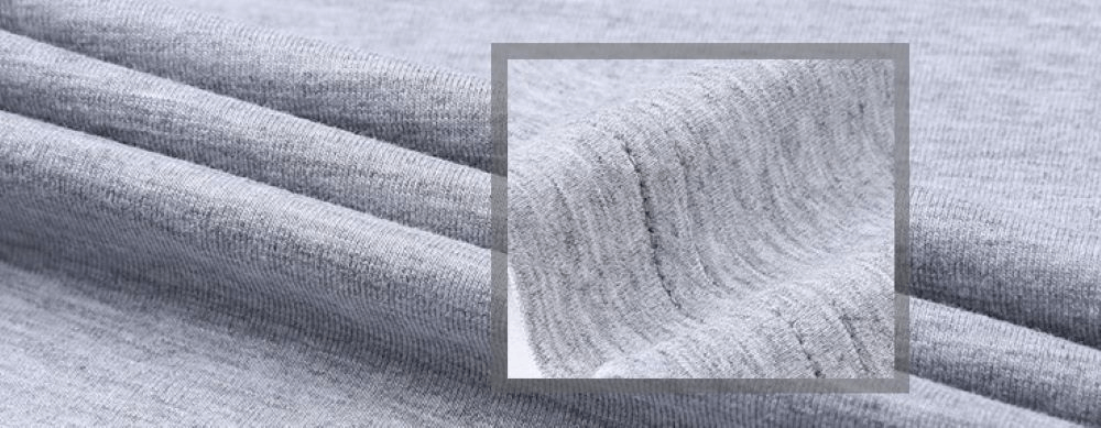 Close-up of soft, stretchy light gray cotton fabric showing textured detail and breathability, ideal for casual male V-neck t-shirt.