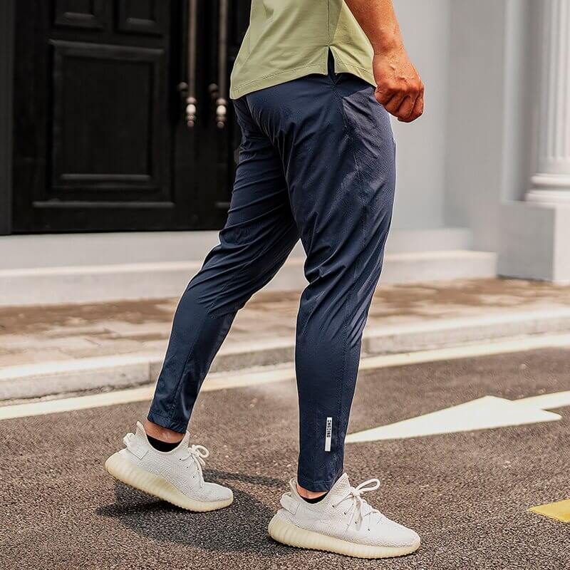 Casual male long sweatpants for running, featuring polyester-spandex blend and elastic waist for comfort. Stylish workout trousers.