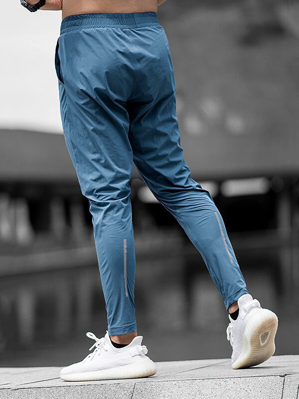 Man running in blue casual long sweatpants, sports workout trousers with elastic waist, perfect for male running. SF0682