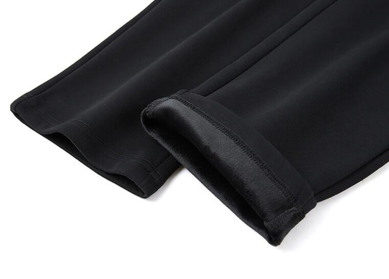 Close-up of casual men's windproof thick black pants with warm lining and ankle-length design.