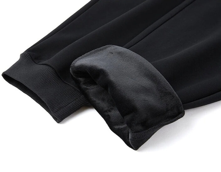 Close-up of black windproof men's thick pants with fleece lining and elastic cuffs for warmth and style - SF0622.