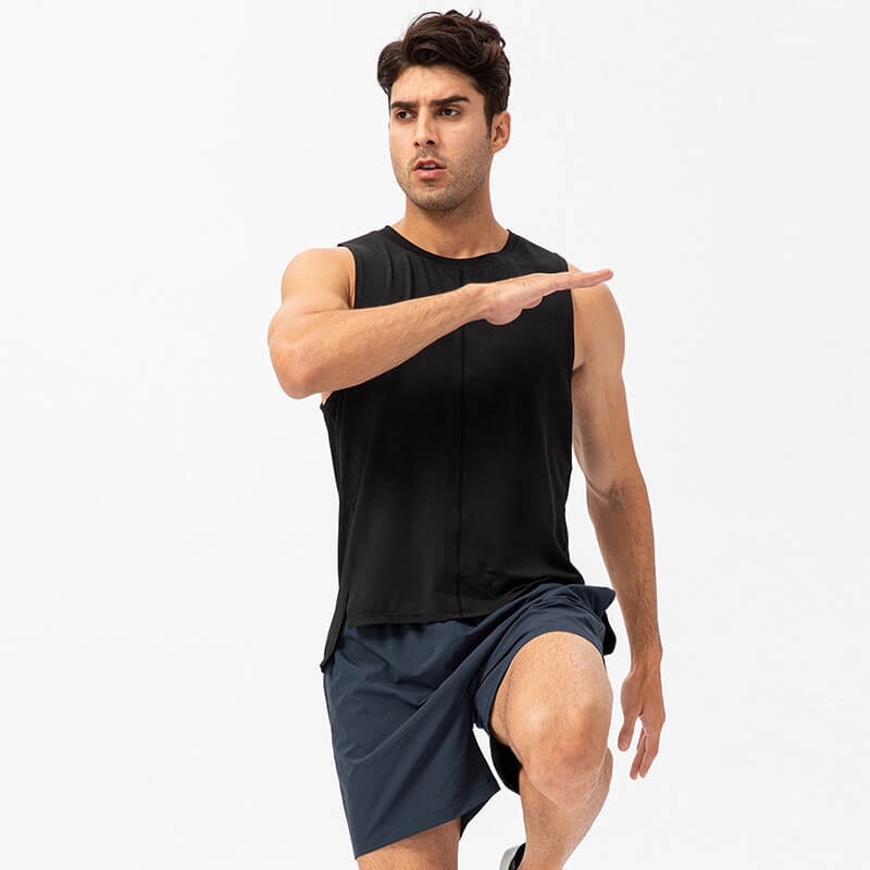Man wearing a casual black O-neck mesh tank top and navy shorts, performing a dynamic exercise move.