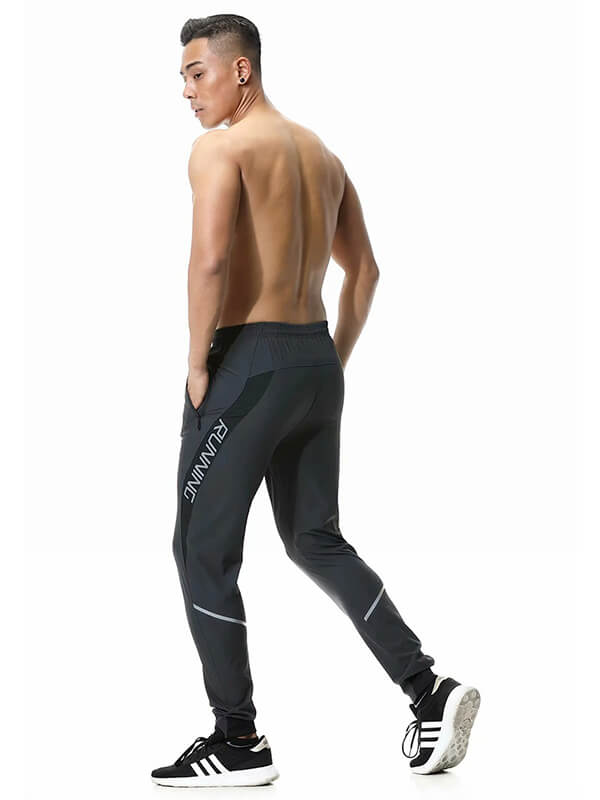 Model wearing black Casual Running Joggers with Zipper Pockets, showcasing secure fit and style for men. Perfect for sporty look.