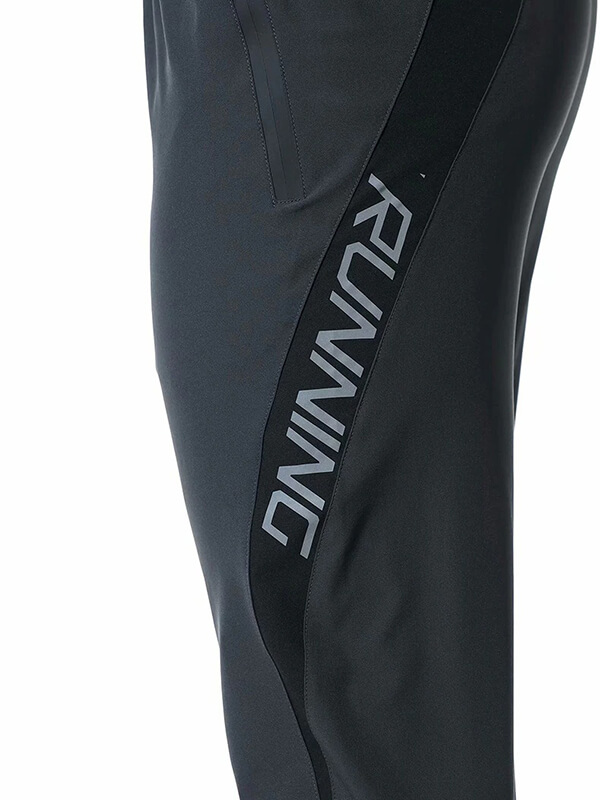 Side view of black running joggers with "RUNNING" text and zipper pocket on the side.