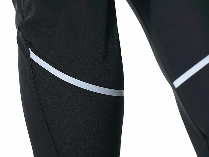 Close-up of black casual running joggers with reflective stripes for men, featuring lightweight polyester fabric and zipper pockets.