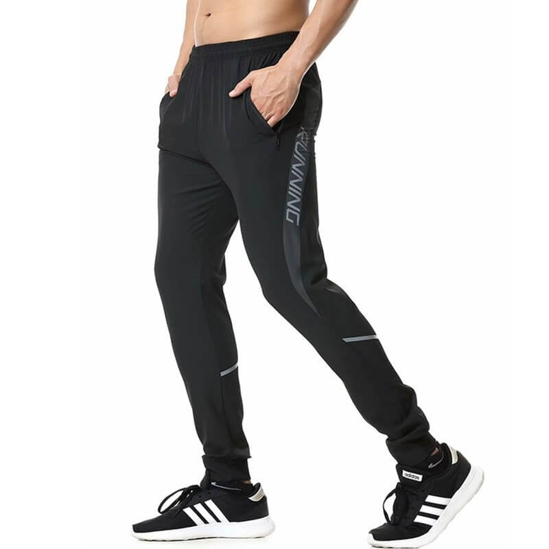 Black casual running joggers with zipper pockets for men, featuring elastic waistband, shown with sneakers. Perfect for a secure fit.