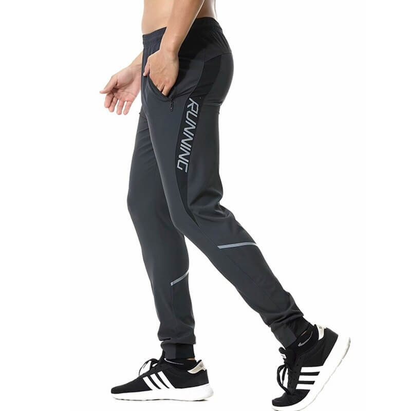 Side view of men wearing casual running joggers with zipper pockets, perfect for jogging and sports in black color.
