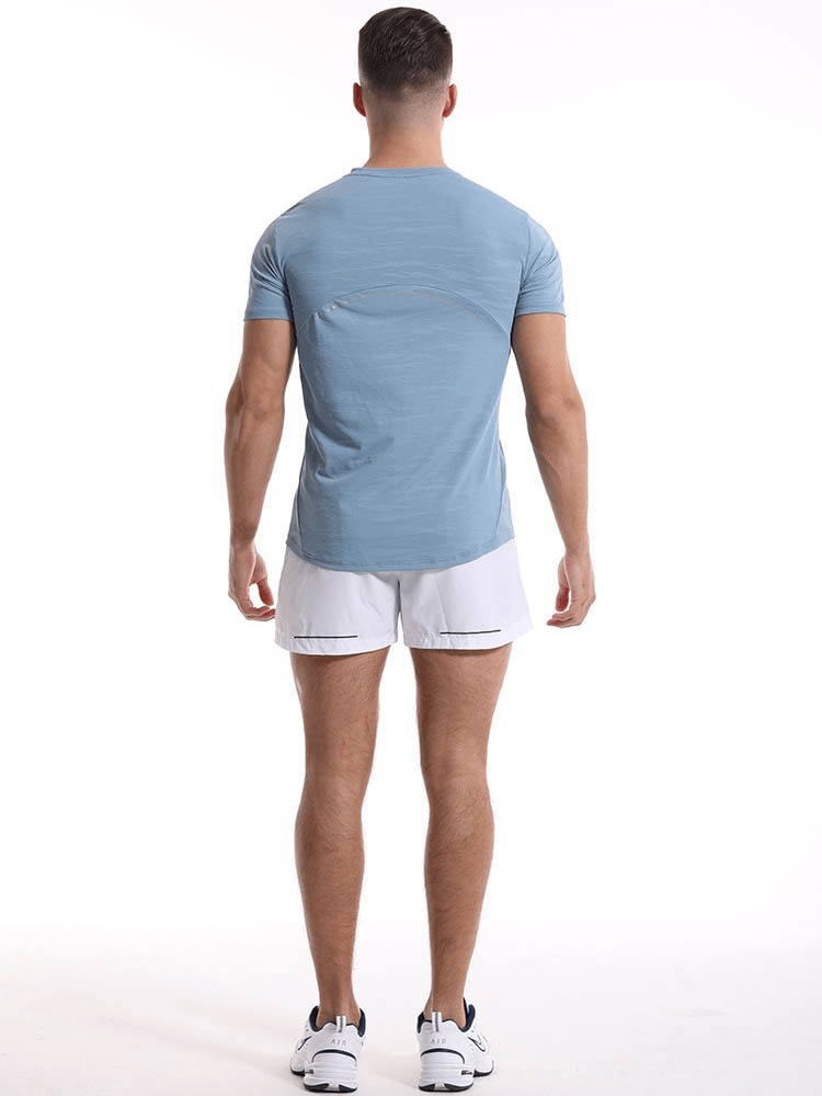 Back view of a man wearing a blue Casual Short Sleeves Basketball Elastic T-shirt and white shorts, ideal for sports activities. SF1043.