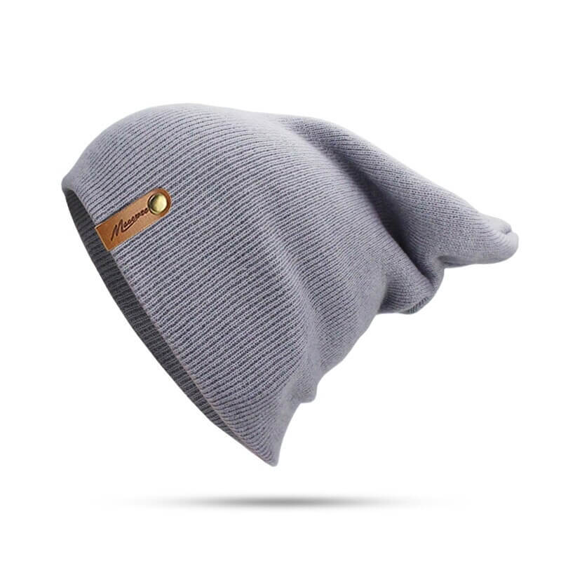 Casual solid color knitted beanie, thick warm soft hat for winter, unisex style, in light grey with logo detail.