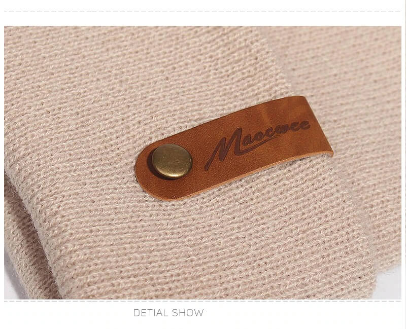 Close-up of casual solid color knitted beanie with leather tag detail, showcasing thick warm soft fabric for winter warmth.