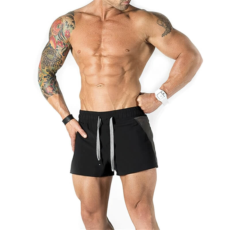 Man wearing casual training drawstring short shorts for gym and sports activities.