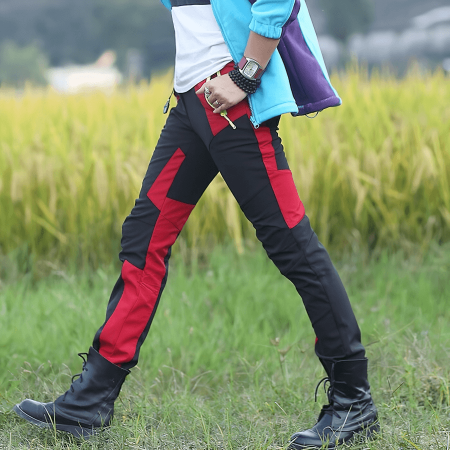 Person wearing Cold Resistance Waterproof Fleece Pants in black and red, ideal for skiing and outdoor activities, walking in nature.