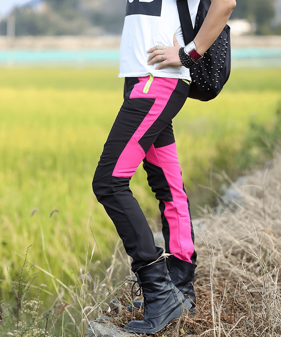 Person wears Cold Resistance Waterproof Fleece Pants in black and pink, perfect for skiing and outdoor activities, with fields in the background.