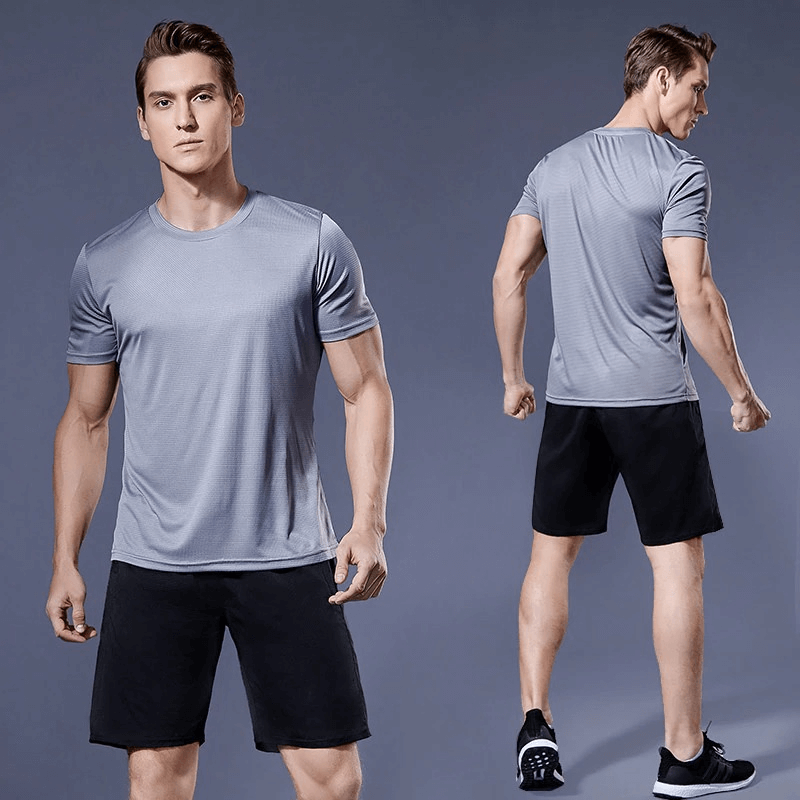 Model wearing a gray compression men's running T-shirt, muscle fit, showcasing front and back views. Ideal for training and comfortable movement.