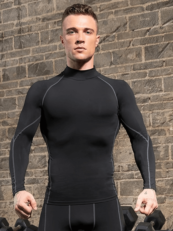 Man wearing a black compression quick-dry long sleeve t-shirt for running, perfect fit and performance, against brick wall backdrop.